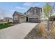 Charming two-story home with a three-car garage and stone accents at 6802 S Uriah St, Aurora, CO 80016