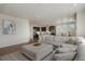 Open concept living room showcasing kitchen, dining area, and comfortable lounge seating at 6802 S Uriah St, Aurora, CO 80016