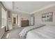 Bright main bedroom showcases a neutral color palette, ensuite bath, and walk-in closet at 6802 S Uriah St, Aurora, CO 80016