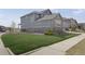 Well-maintained side yard with lush green grass and stone accents on the home at 6802 S Uriah St, Aurora, CO 80016