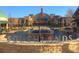 Southlands community view showcasing the shopping center with outdoor seating and architectural details at 6802 S Uriah St, Aurora, CO 80016