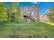 View of the backyard with a deck, stair access, and grassy lawn at 3790 Aspen Hollow Ct, Castle Rock, CO 80104