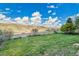 Beautiful backyard view featuring a bright blue sky, green grass, white fence and mountain view at 3790 Aspen Hollow Ct, Castle Rock, CO 80104