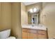 Well-lit bathroom with light wood vanity and countertop, with a neutral wall color and classic fixtures at 3790 Aspen Hollow Ct, Castle Rock, CO 80104