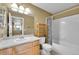 Neutral bathroom with a single sink, a wooden shelving unit, and a shower/tub combo at 3790 Aspen Hollow Ct, Castle Rock, CO 80104