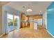 Bright kitchen with hardwood floors, an island, and sliding glass doors leading to a deck with scenic views at 3790 Aspen Hollow Ct, Castle Rock, CO 80104