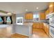 Modern kitchen showcasing an island, laminate countertops, views of the backyard, and wood cabinets at 3790 Aspen Hollow Ct, Castle Rock, CO 80104