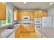 Functional kitchen with wood cabinets, laminate countertops, an island, and essential appliances at 3790 Aspen Hollow Ct, Castle Rock, CO 80104