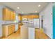 Well-lit kitchen featuring wood floors, an island, wooden cabinets, and modern appliances at 3790 Aspen Hollow Ct, Castle Rock, CO 80104