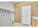 Spacious laundry room with washer/dryer hookups, a sink, and a white entry door at 3790 Aspen Hollow Ct, Castle Rock, CO 80104