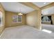 Open living room with large windows, neutral walls, and plush carpeting offers a versatile living space at 3790 Aspen Hollow Ct, Castle Rock, CO 80104