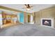 Open-concept living area showcasing a fireplace, plush carpeting, and seamless flow into the kitchen at 3790 Aspen Hollow Ct, Castle Rock, CO 80104