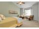 Inviting bedroom with neutral tones, featuring a comfortable bed, two chairs, and ample natural light, perfect for relaxation at 3342 Springmeadow Cir, Castle Rock, CO 80109