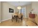 Neutral dining area with natural light, wood furniture and flooring, with a modern light fixture at 3342 Springmeadow Cir, Castle Rock, CO 80109