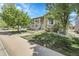 Inviting home featuring a charming covered porch with steps leading up, complemented by mature trees and a green lawn at 3342 Springmeadow Cir, Castle Rock, CO 80109