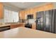 Kitchen with light wood cabinetry, island with quartz countertops and stainless steel appliances at 3342 Springmeadow Cir, Castle Rock, CO 80109