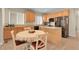 Bright kitchen with breakfast nook, island, and stainless steel refrigerator at 3342 Springmeadow Cir, Castle Rock, CO 80109