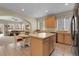 Open kitchen featuring an island, light wood cabinetry, and a view into the adjacent living room at 3342 Springmeadow Cir, Castle Rock, CO 80109