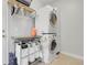 Efficient laundry room with stacked washer and dryer, utility sink, and ample storage at 3342 Springmeadow Cir, Castle Rock, CO 80109