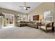 Spacious living room with vaulted ceiling, large sectional couch and access to outdoor deck at 3342 Springmeadow Cir, Castle Rock, CO 80109
