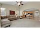 Bright and airy living room open to the kitchen with high ceilings and neutral decor at 3342 Springmeadow Cir, Castle Rock, CO 80109
