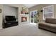 Inviting living room featuring a cozy fireplace, neutral carpet, and natural light from sliding glass doors at 3342 Springmeadow Cir, Castle Rock, CO 80109