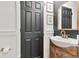 Stylish powder room featuring a decorative mirror, modern fixtures, and dark accents at 10042 Hudson St, Thornton, CO 80229