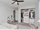 This is a well lit bedroom with carpeted floors, a mirror vanity, and closet organizers at 10042 Hudson St, Thornton, CO 80229