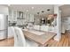 Dining area with wooden table and chairs, leading to a modern kitchen and comfortable living space at 10042 Hudson St, Thornton, CO 80229