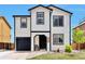 Inviting exterior featuring a two-story home with black trim, landscaped yard, and a cozy front porch at 10042 Hudson St, Thornton, CO 80229
