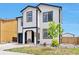 Two-story home with white siding, black trim, and landscaped front yard at 10042 Hudson St, Thornton, CO 80229