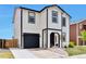 Charming two-story home with black trim, garage, manicured lawn, and welcoming front entrance at 10042 Hudson St, Thornton, CO 80229
