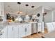 Bright kitchen featuring granite counters, stainless appliances, and contemporary white cabinets at 10042 Hudson St, Thornton, CO 80229
