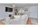 Comfortable living room with fireplace, TV, neutral furnishings, wood floors, and natural light at 10042 Hudson St, Thornton, CO 80229