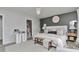 This is a main bedroom with a large bed, dark accent wall, modern chandelier, and stylish furniture at 10042 Hudson St, Thornton, CO 80229