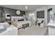 This is a main bedroom with a large bed, dark accent wall, modern chandelier, and sitting area with lots of natural light at 10042 Hudson St, Thornton, CO 80229