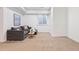 Finished basement with plush carpeting and a comfortable seating area at 4190 W Alameda Ave, Denver, CO 80219