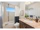 Bathroom with a modern vanity, toilet, tub and window at 4190 W Alameda Ave, Denver, CO 80219