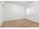 A light and bright bedroom featuring neutral carpet, a window, and ample closet space at 4190 W Alameda Ave, Denver, CO 80219