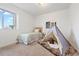Bright bedroom with a neutral carpet, single bed, and ' teepee at 4190 W Alameda Ave, Denver, CO 80219