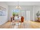 Bright dining area featuring hardwood floors, stylish chandelier and table that seats four at 4190 W Alameda Ave, Denver, CO 80219