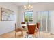 Bright dining area featuring hardwood floors, stylish chandelier and table that seats four at 4190 W Alameda Ave, Denver, CO 80219