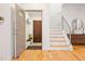 Inviting entryway with hardwood floors, staircase, and decorative mirror at 4190 W Alameda Ave, Denver, CO 80219