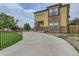 Stylish two-story home with a stone and siding exterior, concrete driveway, and manicured lawn at 4190 W Alameda Ave, Denver, CO 80219