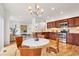 Bright kitchen featuring wood cabinets, granite counters, stainless appliances, and hardwood floors at 4190 W Alameda Ave, Denver, CO 80219