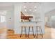 Kitchen and breakfast bar area with pendant lights and wood counter stools at 4190 W Alameda Ave, Denver, CO 80219