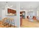 Open-concept design featuring bar seating with kitchen and dining area at 4190 W Alameda Ave, Denver, CO 80219