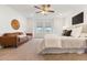 Bright main bedroom with a sitting area, ceiling fan, neutral carpet and contemporary decor at 4190 W Alameda Ave, Denver, CO 80219