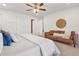 Bright main bedroom with a sitting area, ceiling fan, and access to an ensuite at 4190 W Alameda Ave, Denver, CO 80219