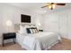 Bright main bedroom featuring bedside tables and lamps, and neutral decor at 4190 W Alameda Ave, Denver, CO 80219